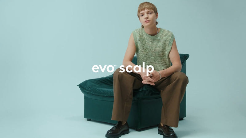Person sitting on a green chair with 'evo scalp' text overlay